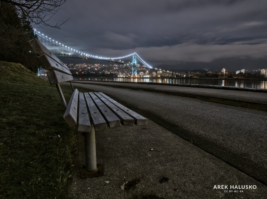Vancouver BC Lions Gate bridge view at night from sitting bench.