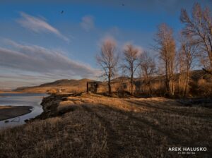 Kamloops BC abandoned farm building on Thompson River at sunset